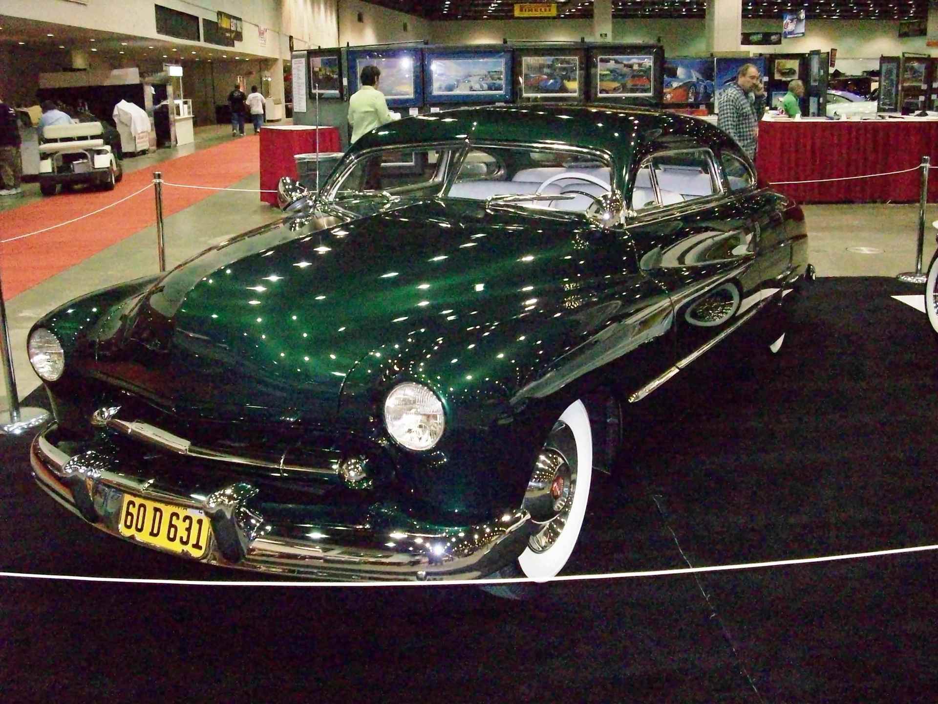 A green car with a license plate that says 60 5 532