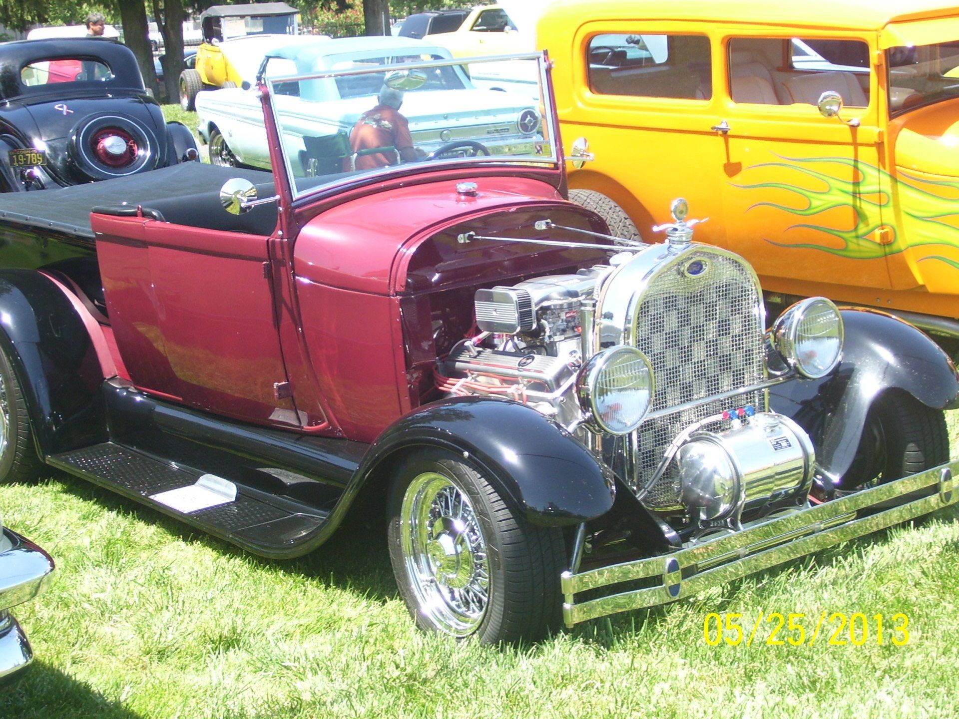 A red car is parked next to a yellow car