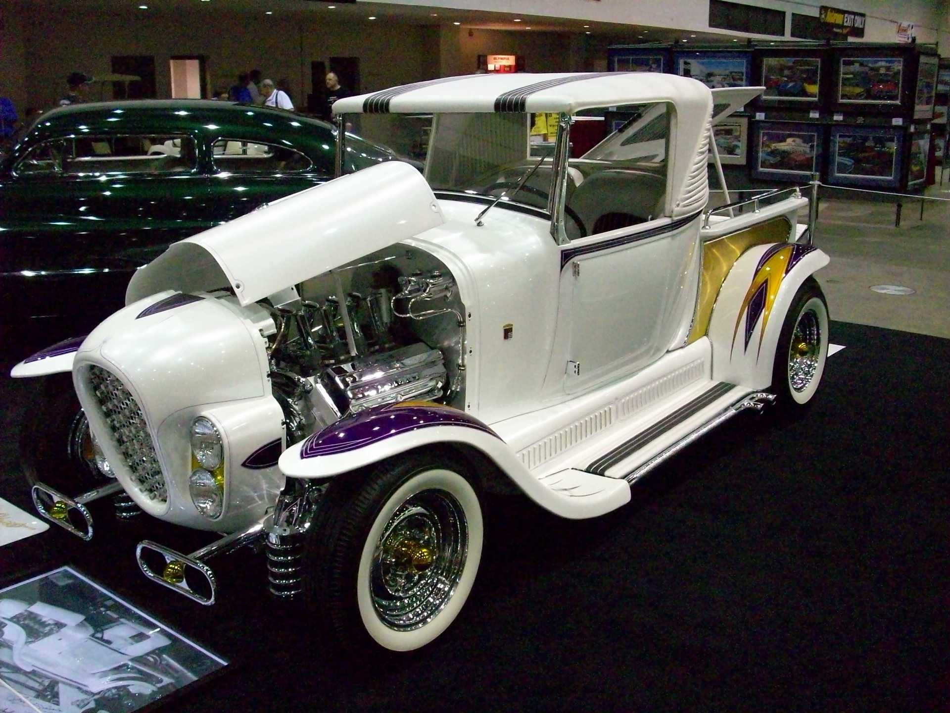 A white and purple car with the hood open