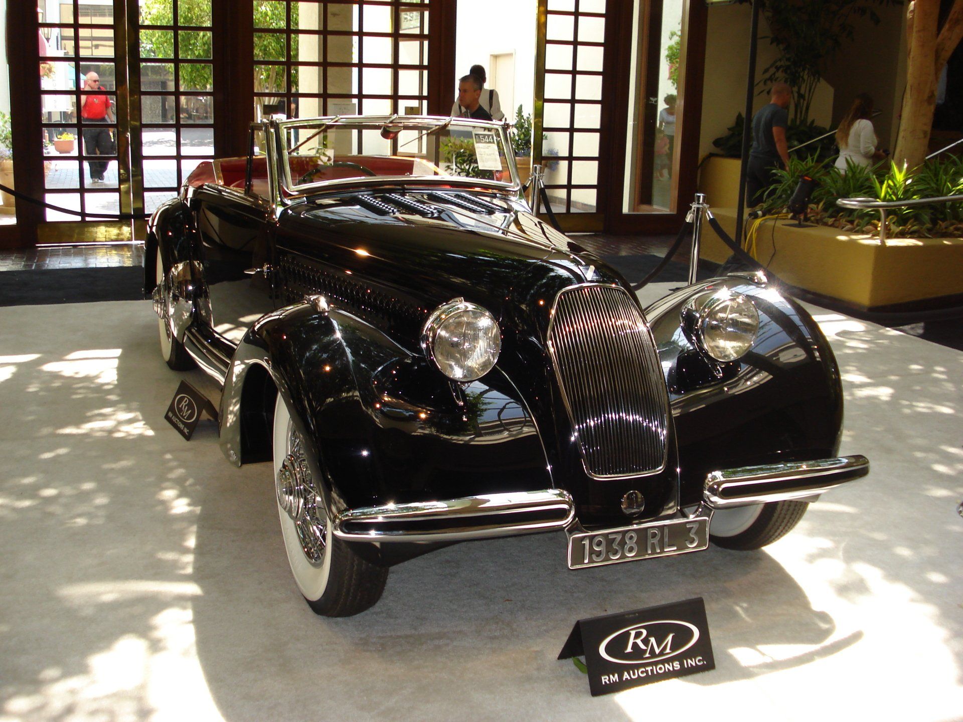 A black car with a license plate that says rm