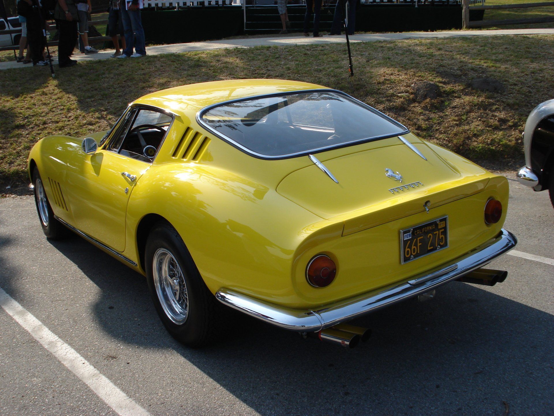 A yellow sports car is parked in a parking lot