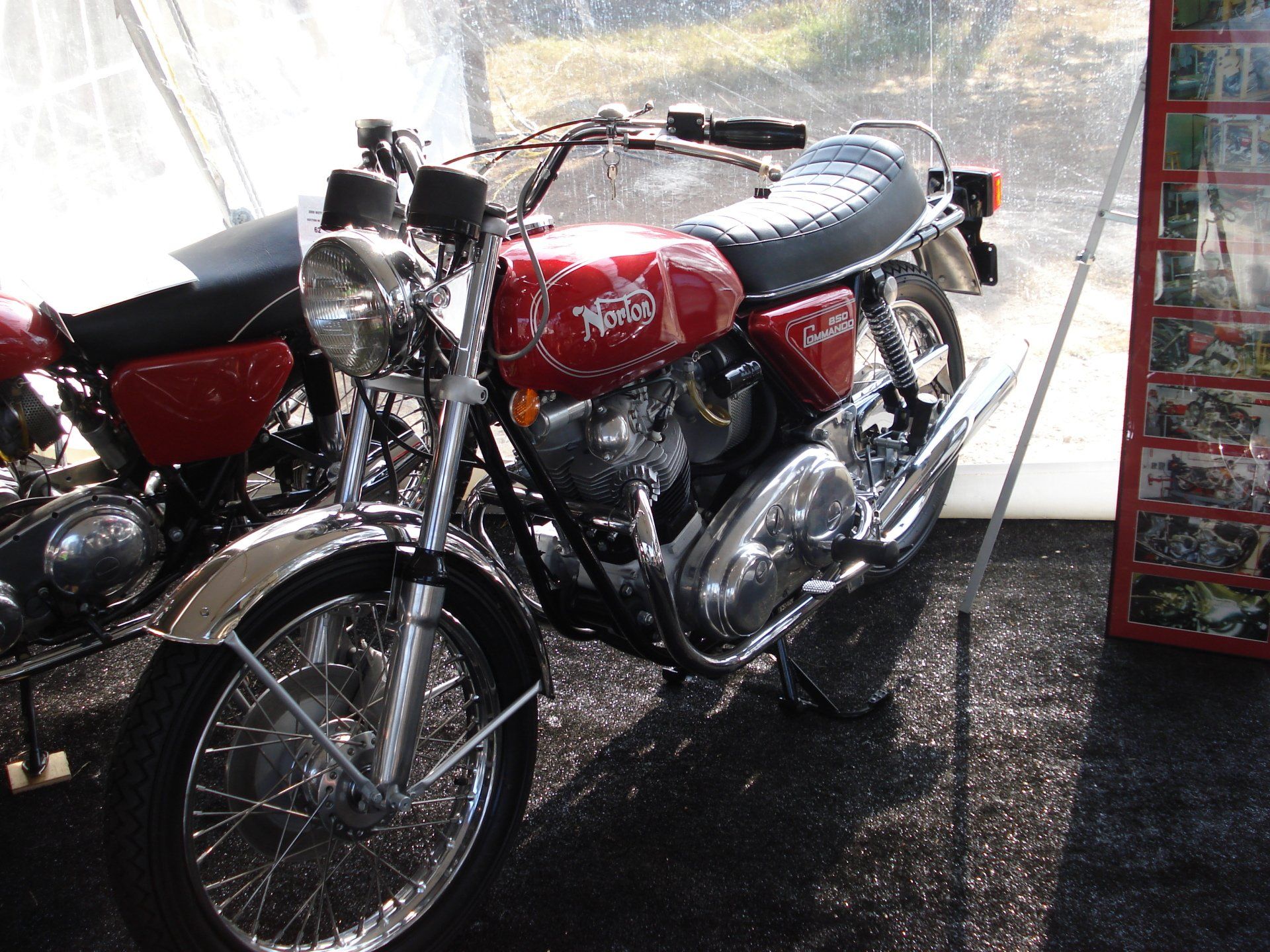 A red motorcycle is parked next to a black motorcycle