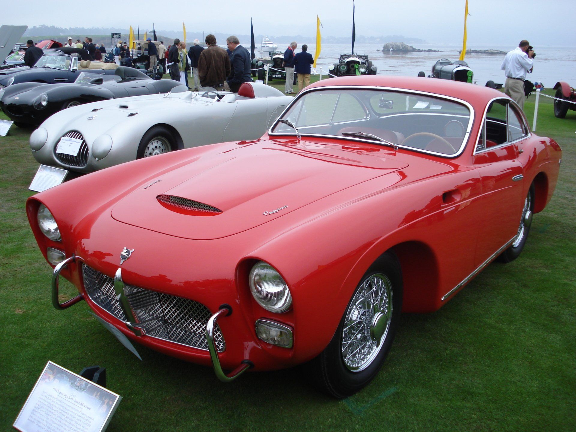 A red car is parked next to a silver car