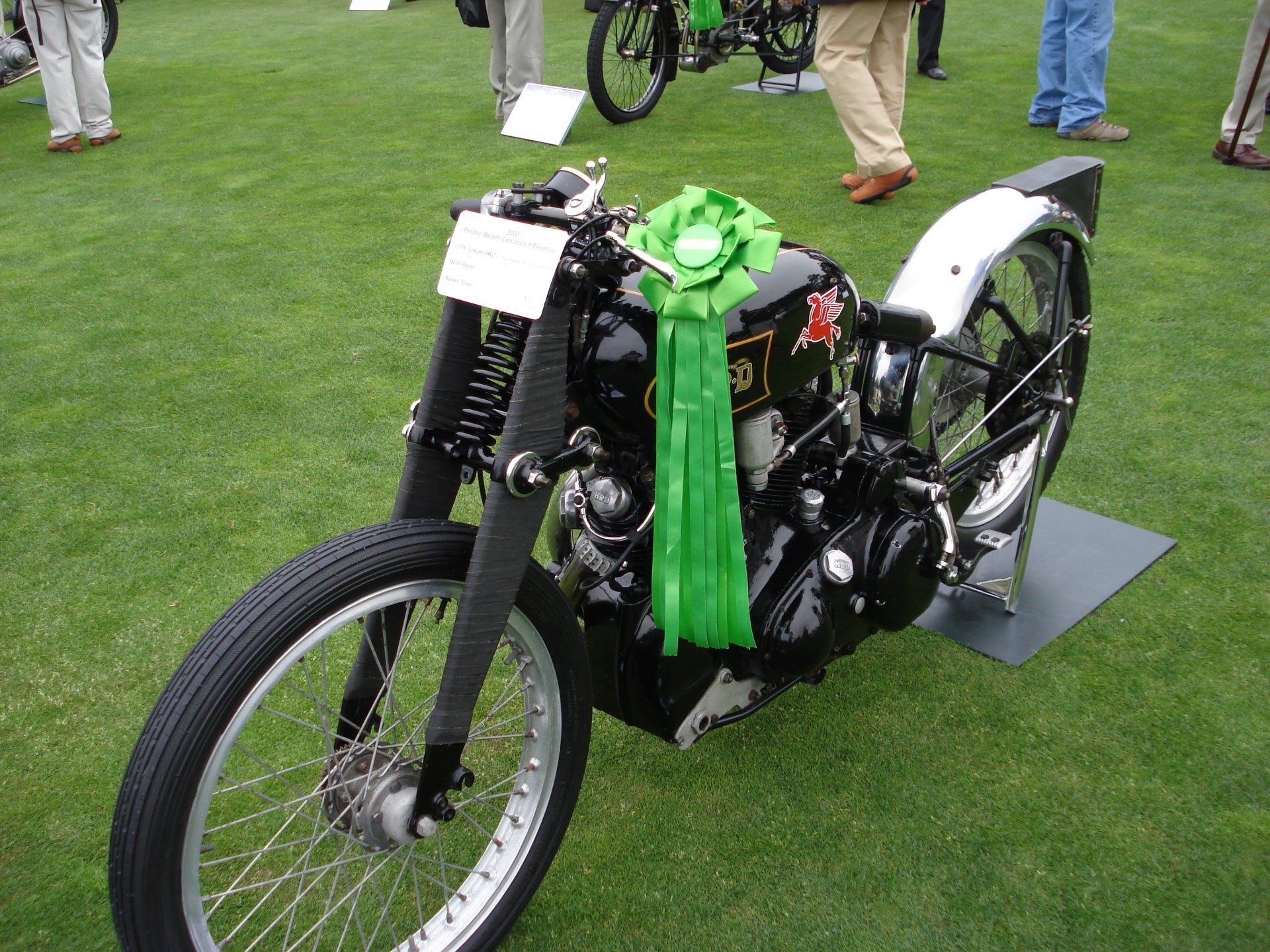 A black motorcycle with a green ribbon around it