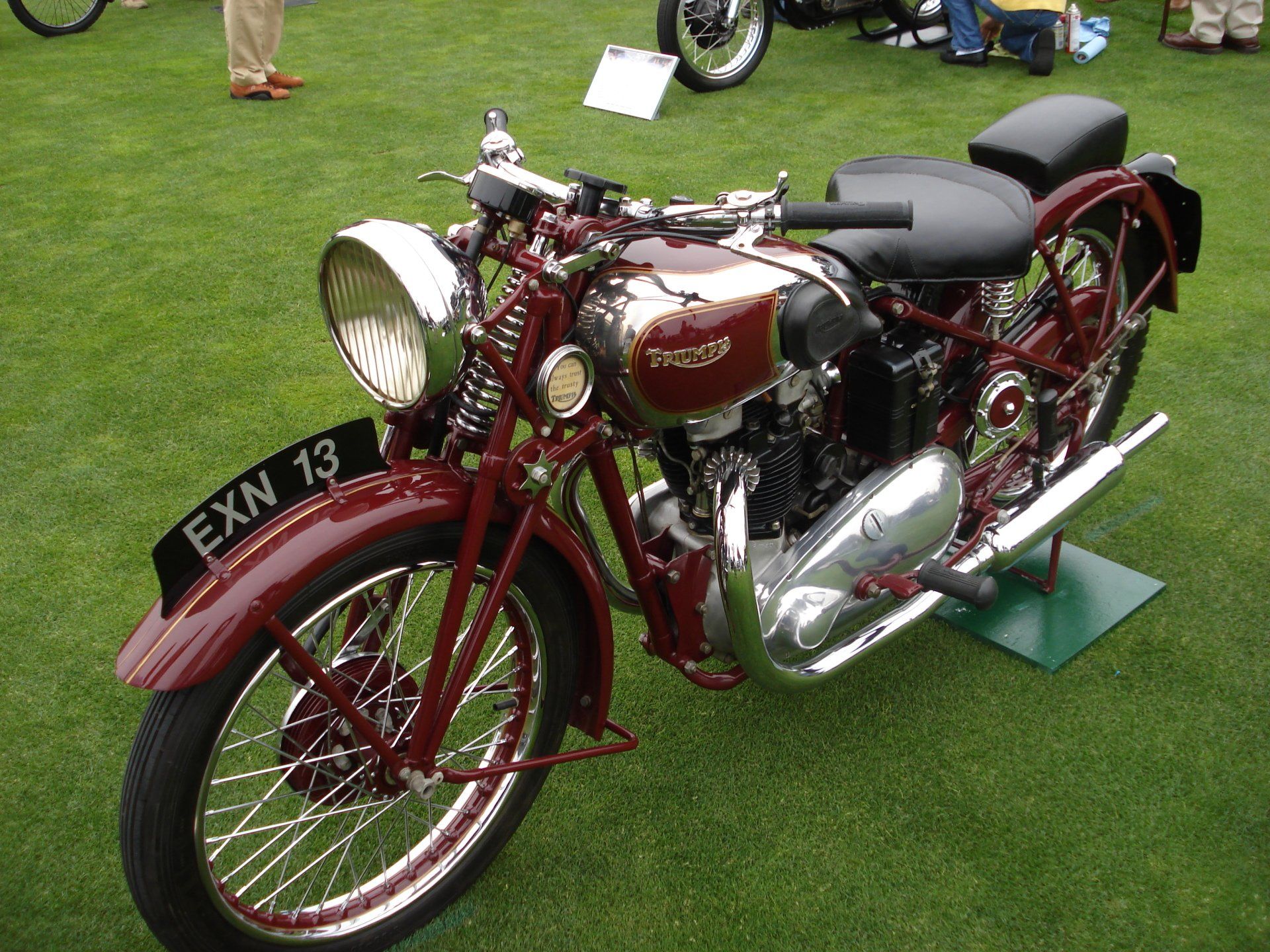 A red motorcycle with a license plate that says exn 13