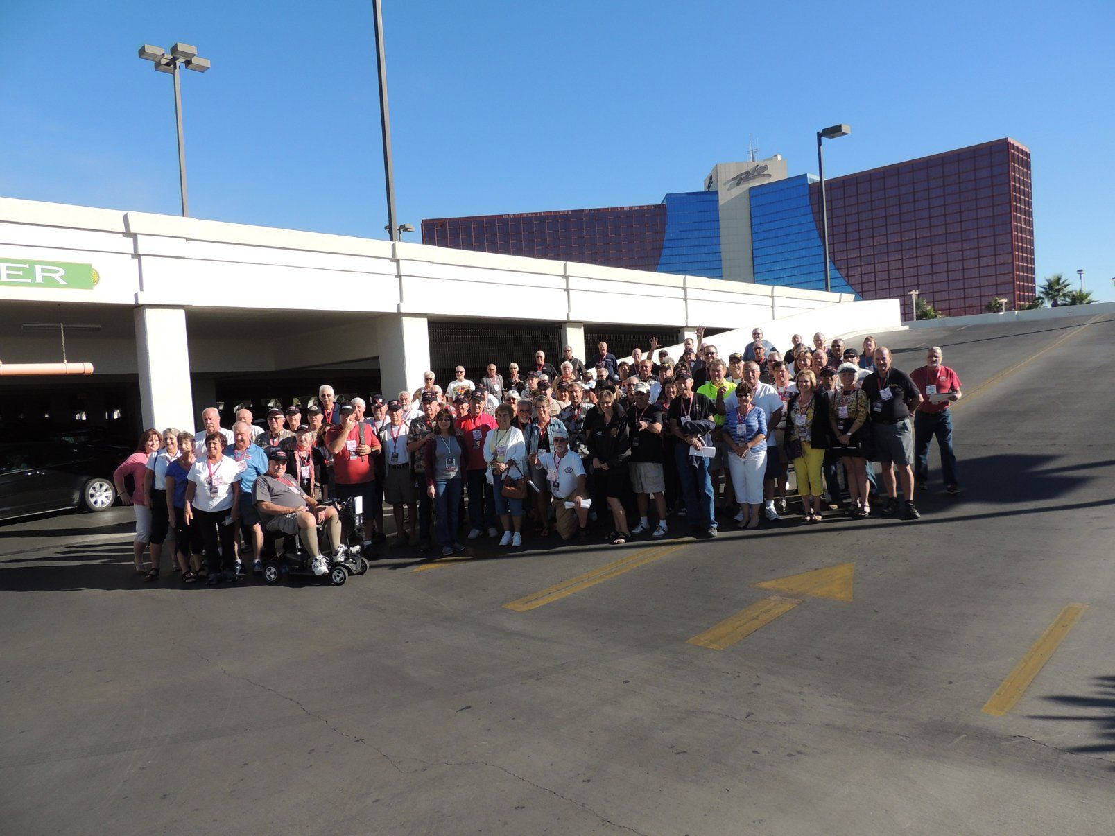 A large group of people are posing for a picture in front of a building that says pr