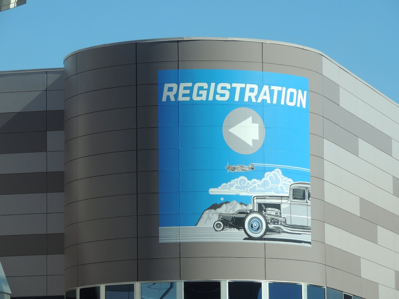A large sign on the side of a building says registration