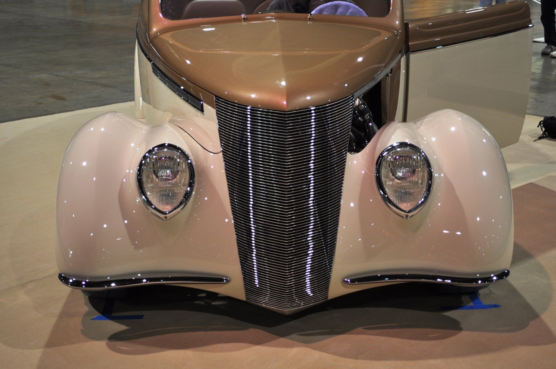 A close up of the front of an old fashioned car