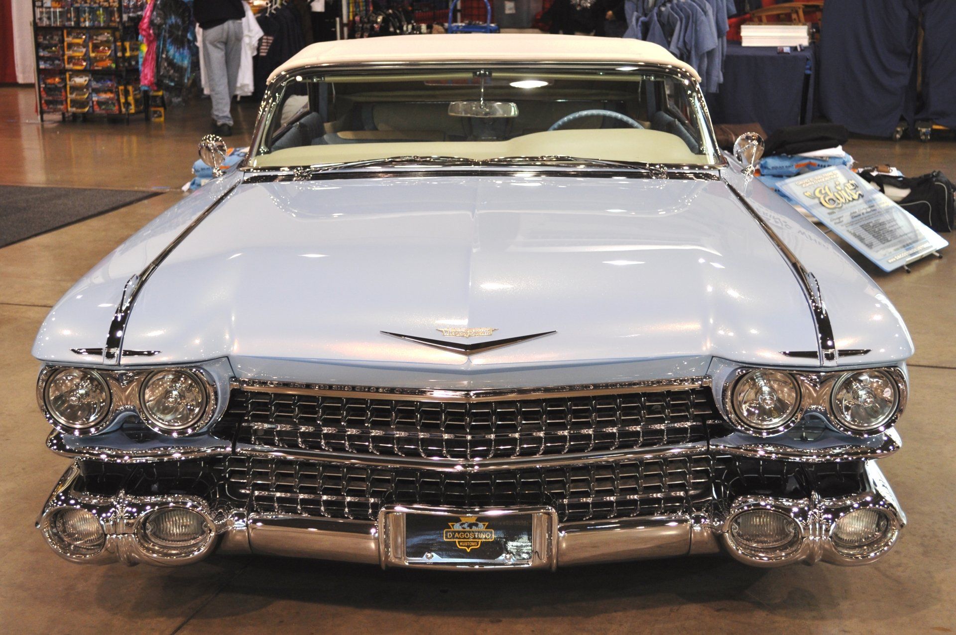 A light blue cadillac is parked in a room