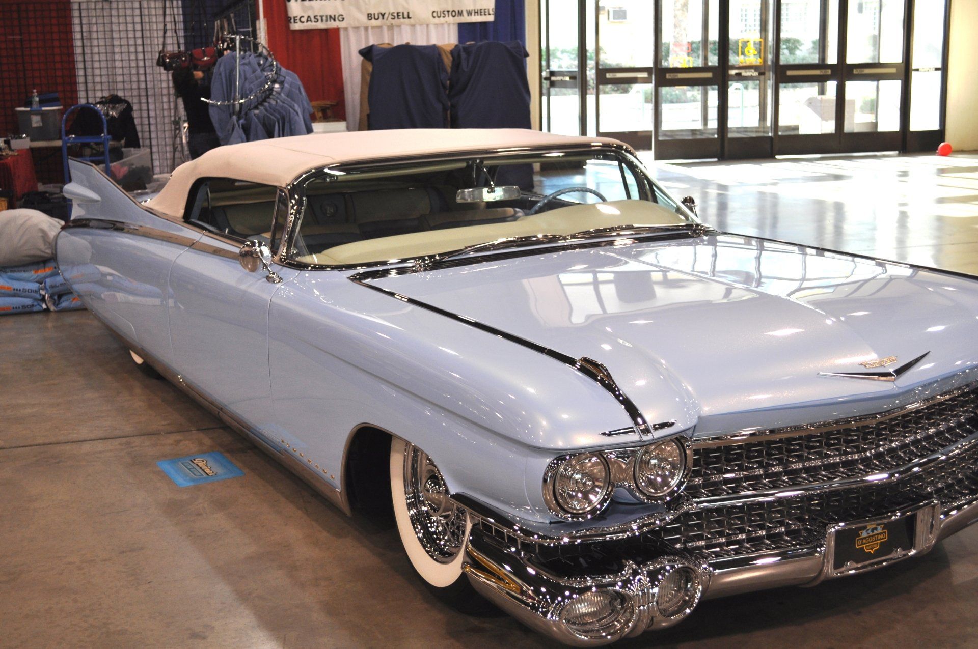 A light blue cadillac is parked in a building