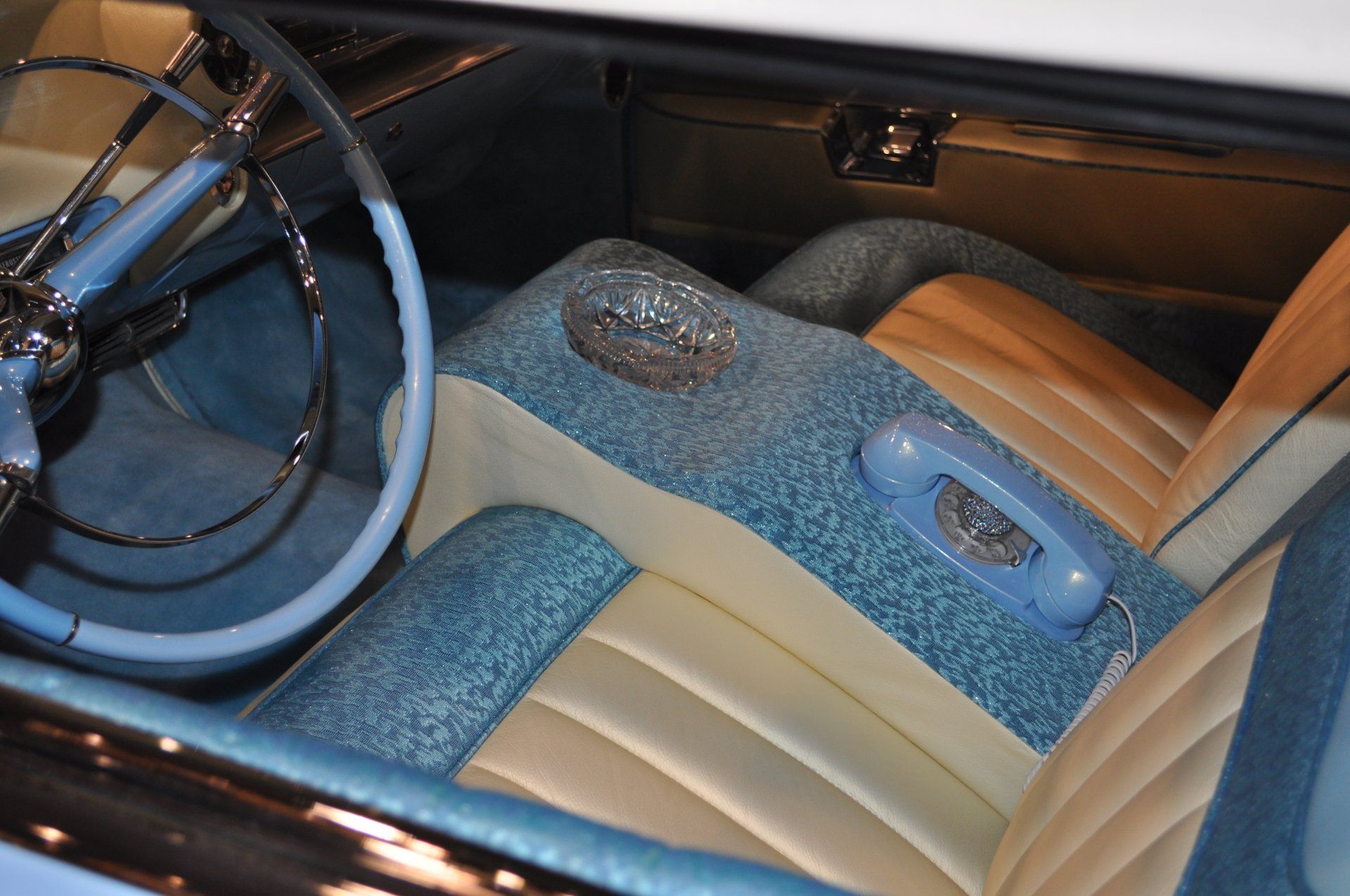 The inside of a car with a phone in the seat