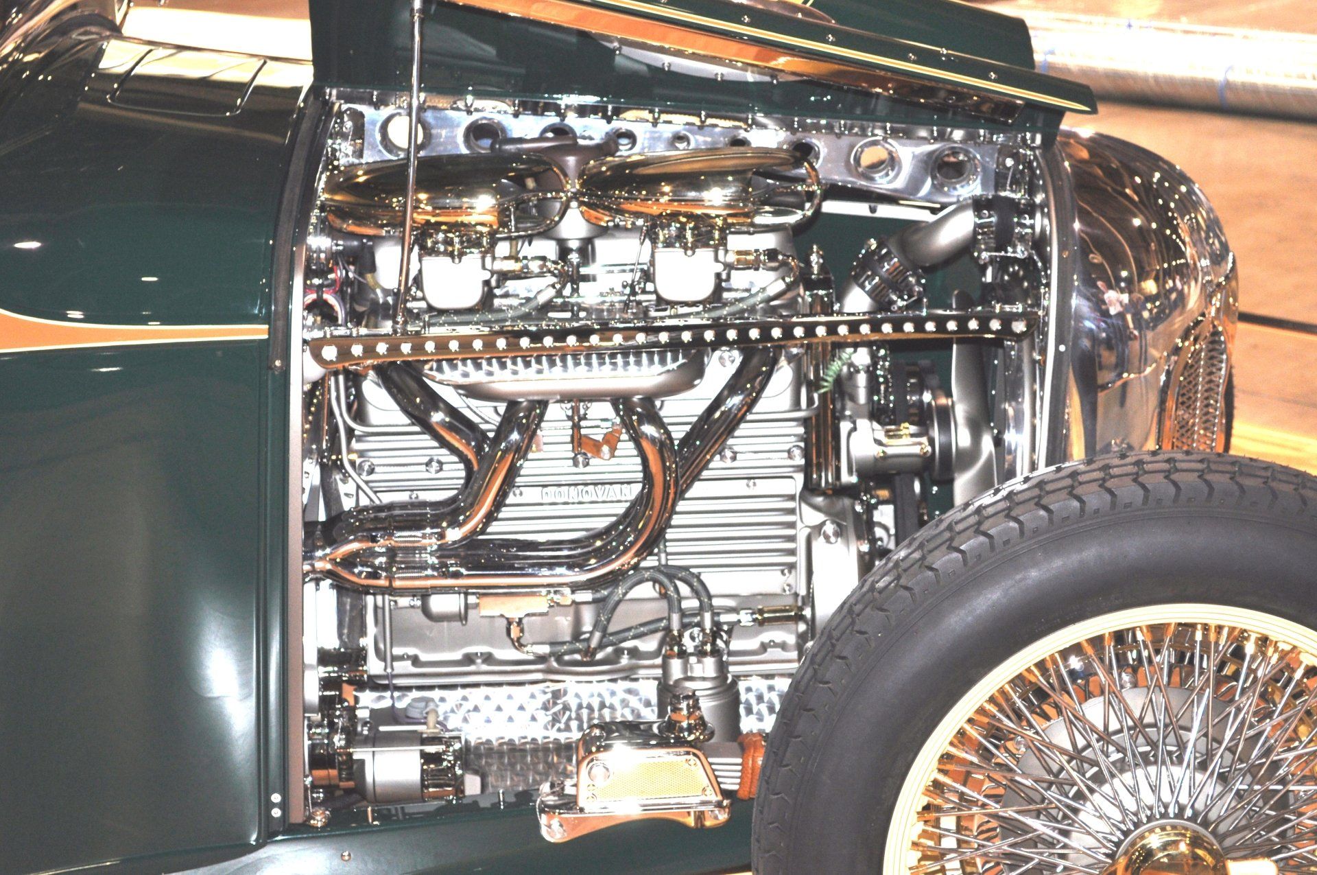 A close up of a car engine with the hood open