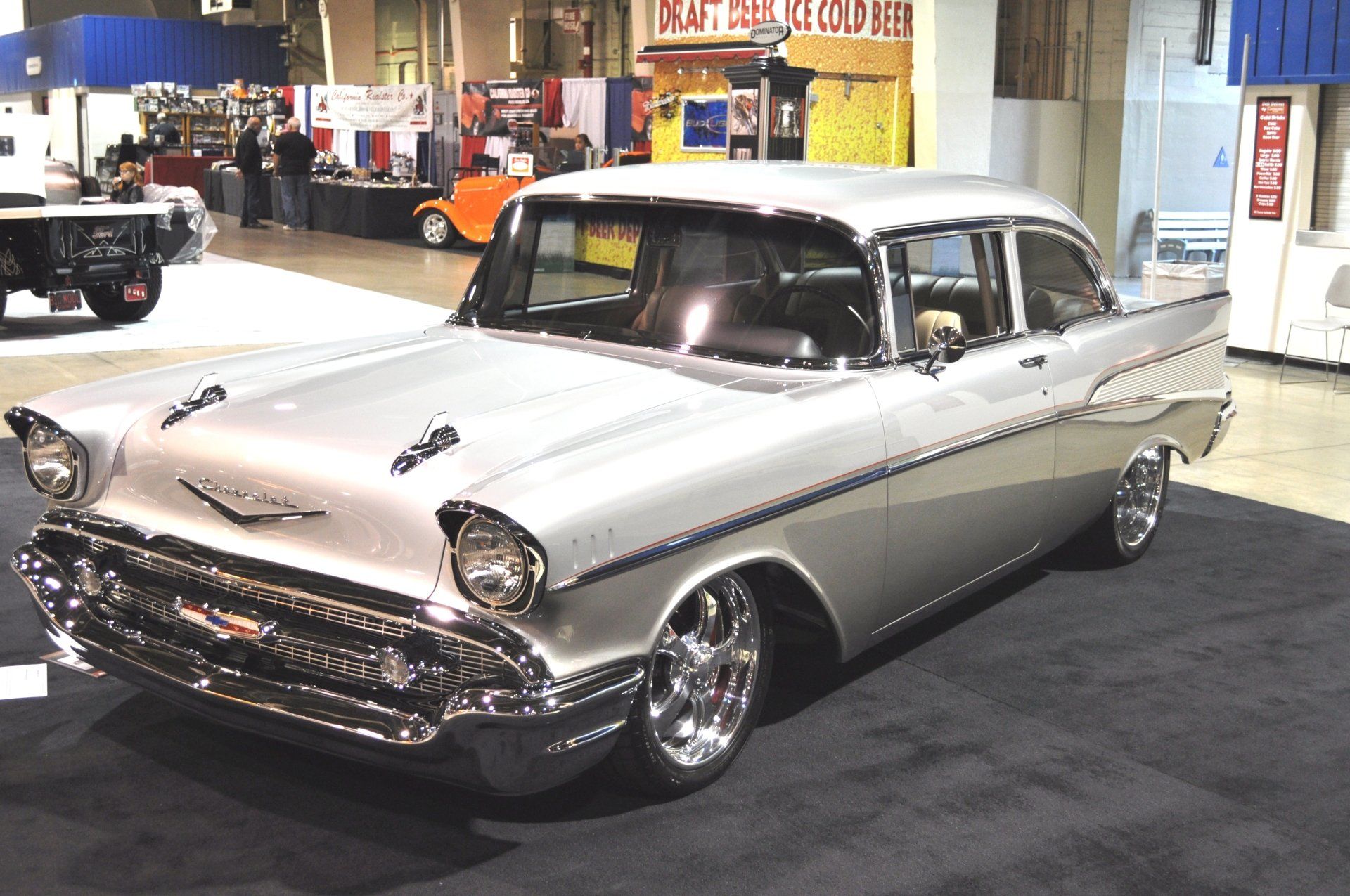 A silver car is parked in front of a sign that says ice cream
