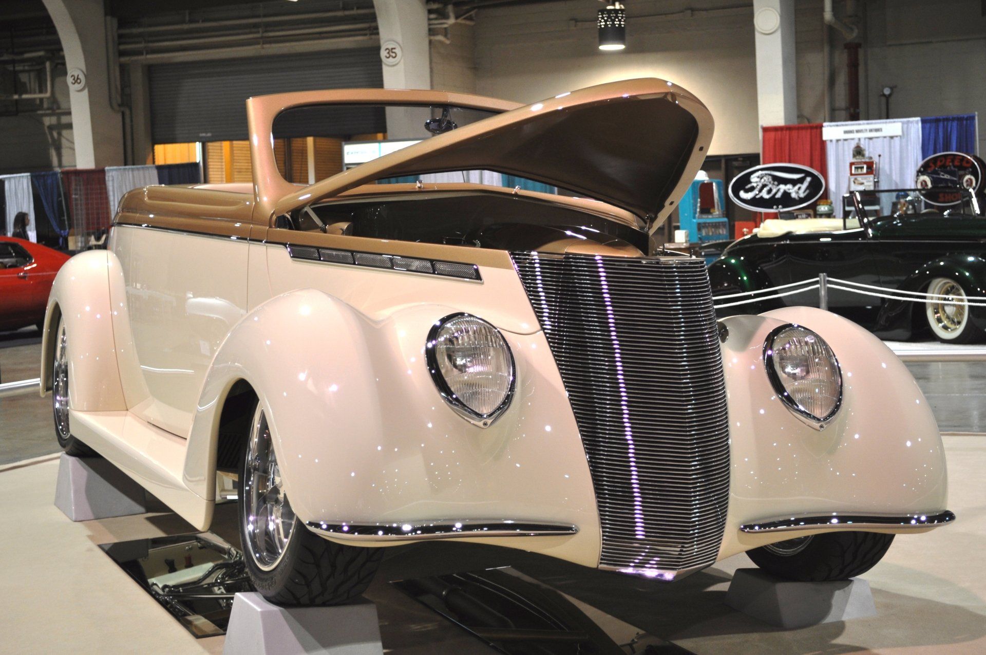 A white ford car with the hood open