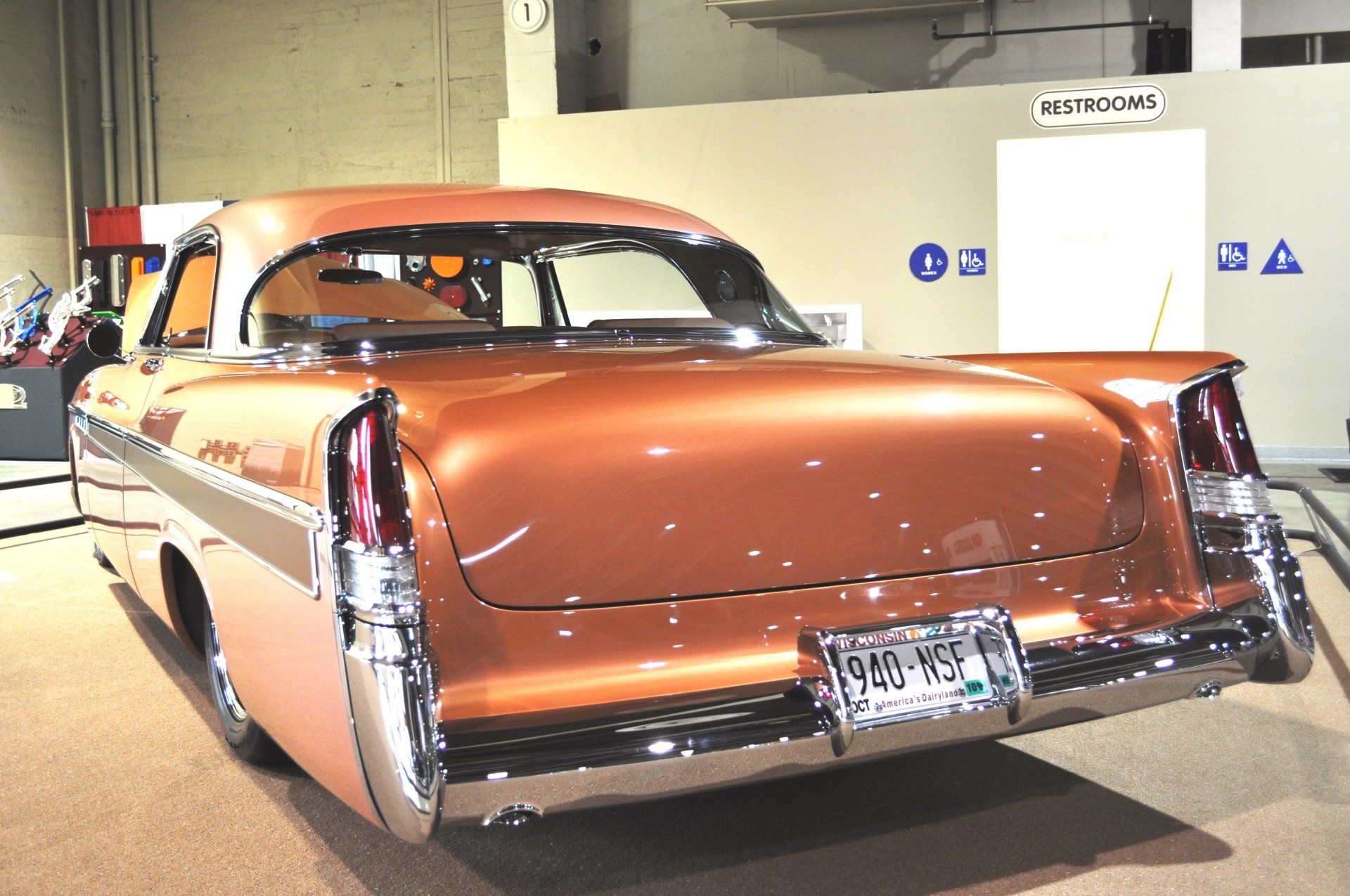 A brown car with a license plate that says 9nc-493