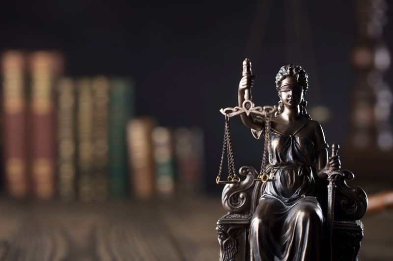 A statue of a person holding a sword and scales