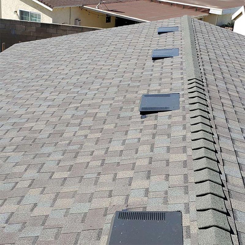 A gray garage with a steeple on top of it