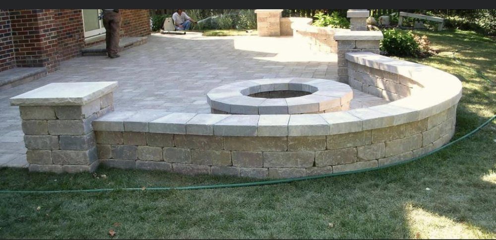 A brick wall with a fire pit in the middle of it
