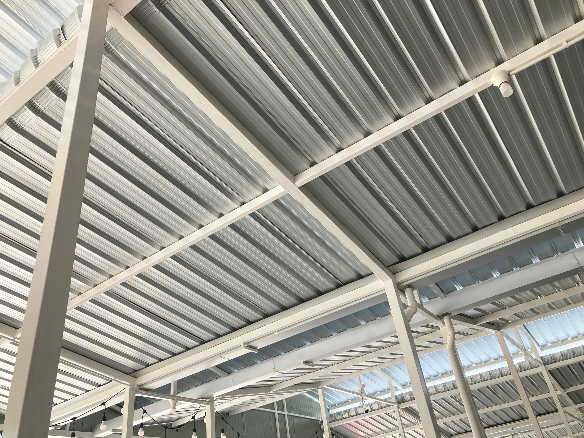Looking up at the ceiling of a building with a metal roof.