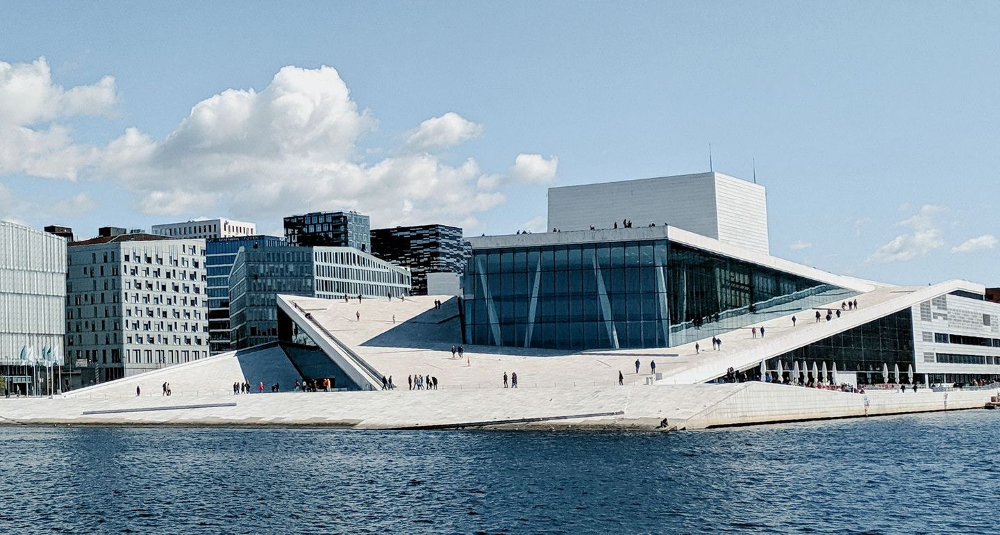 Oslo Opera House exterior with office towers of Barcode districts seen behind