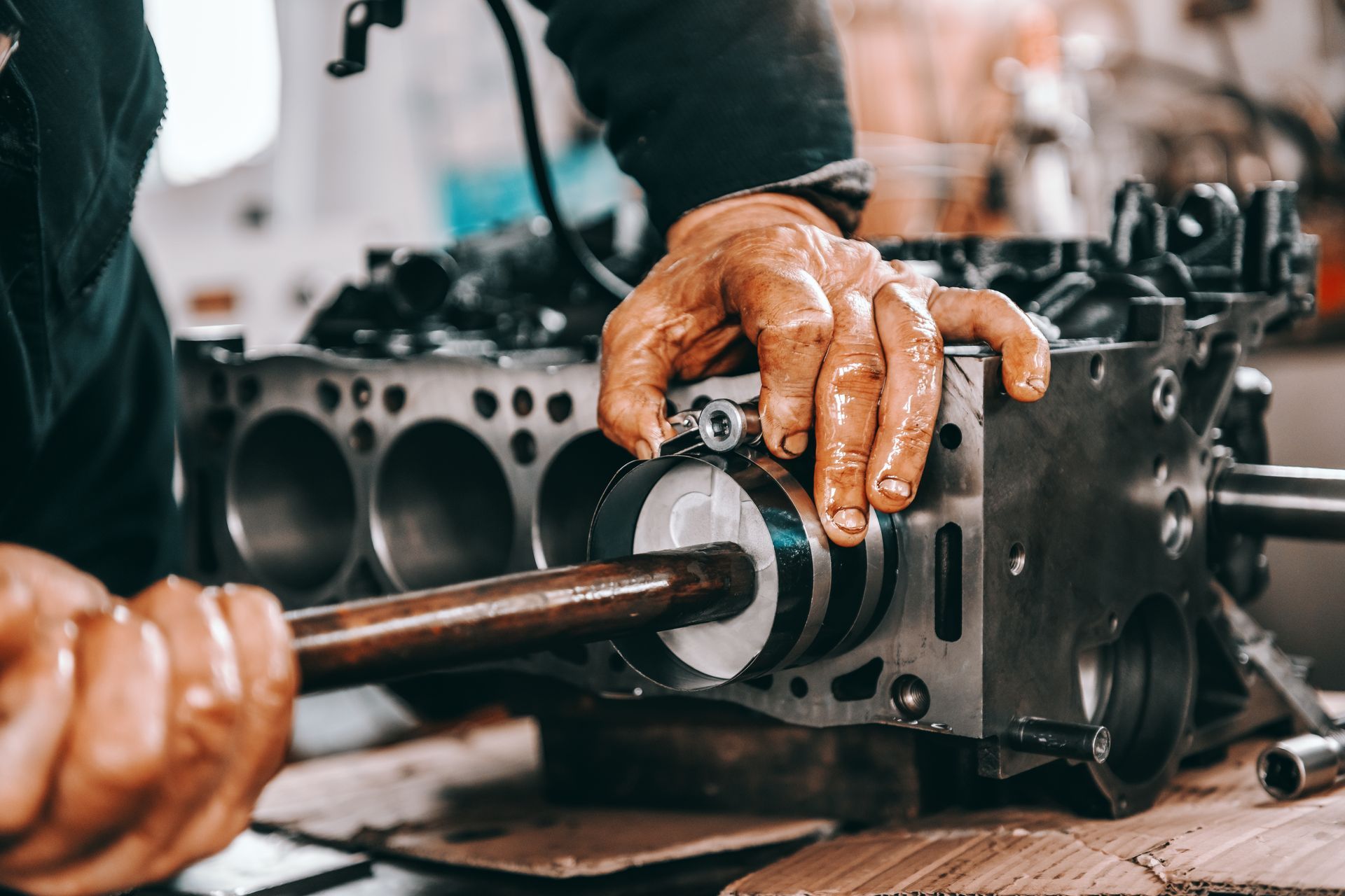 A man is working on a car engine in a garage.