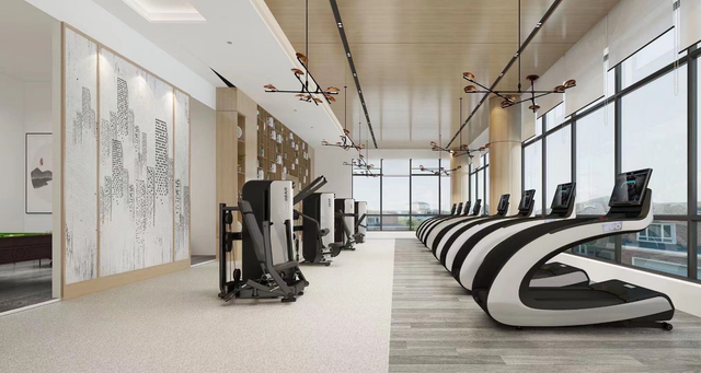 A large gym with a lot of treadmills and a lot of windows.