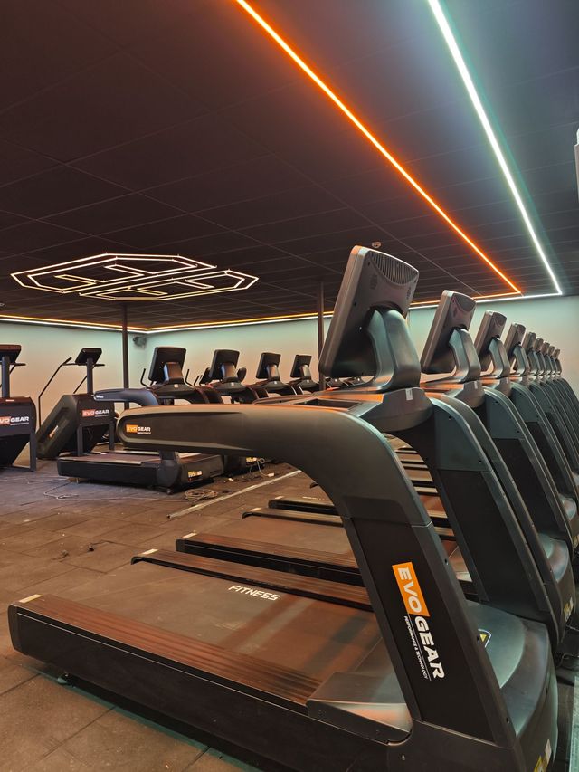 A row of mats are lined up in a gym