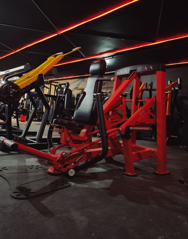 One gym with lots of red and yellow exercise equipment