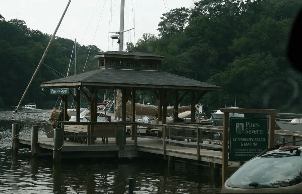 A dock with a gazebo and a sign that says places to swim