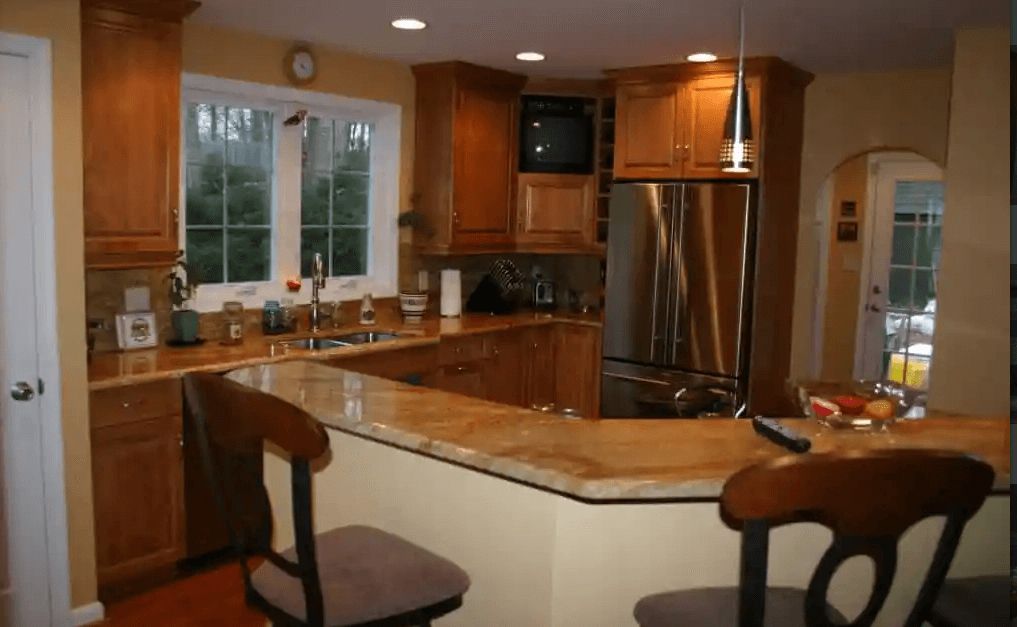 A kitchen with stainless steel appliances and wooden cabinets