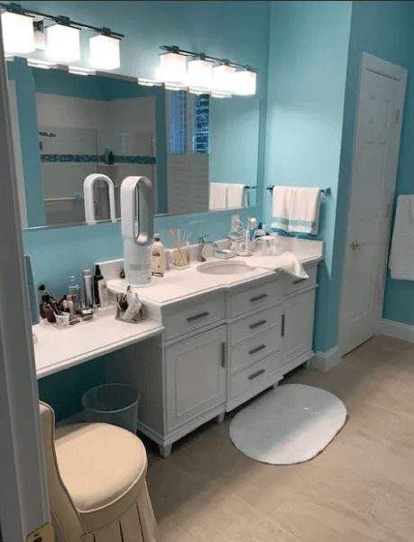 A bathroom with two sinks , a mirror and a vanity.