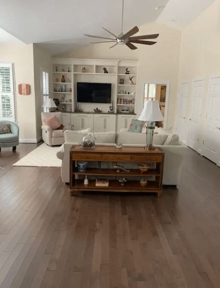 A living room filled with furniture and a ceiling fan