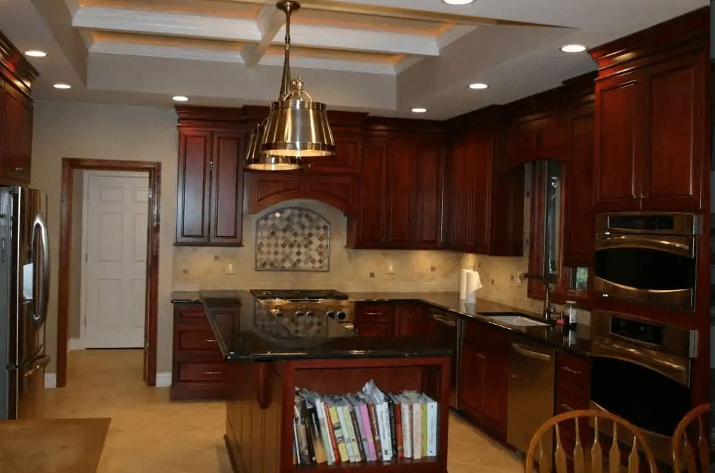 A kitchen with wooden cabinets and stainless steel appliances