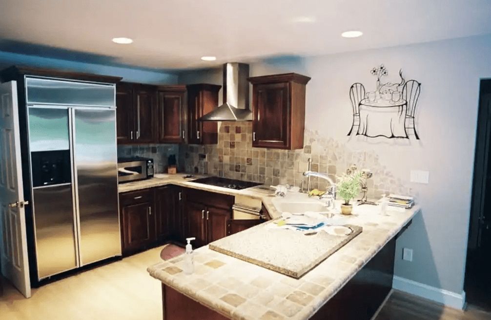 A kitchen with stainless steel appliances and wooden cabinets