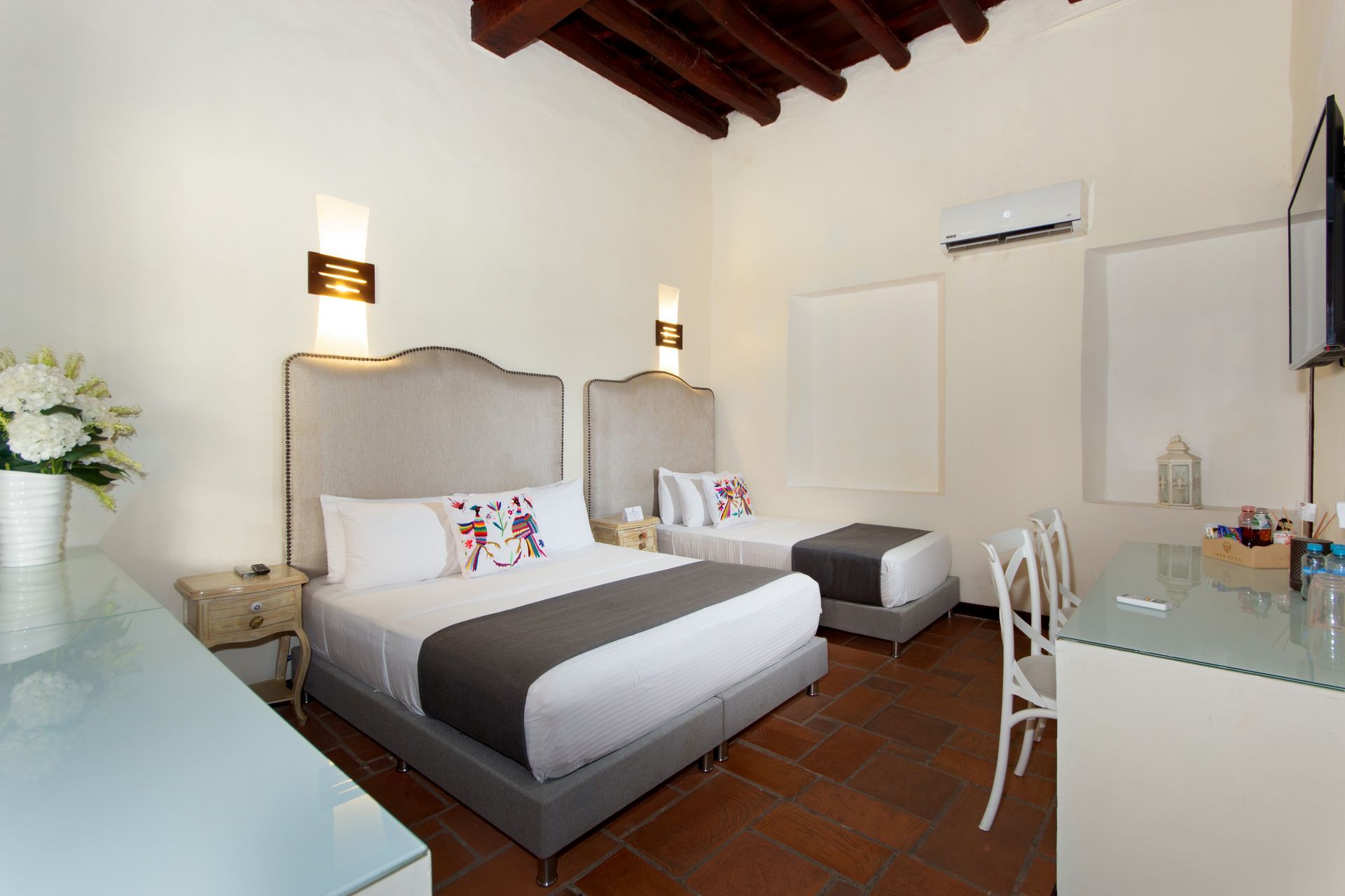 A hotel room with two beds , a desk and a television.