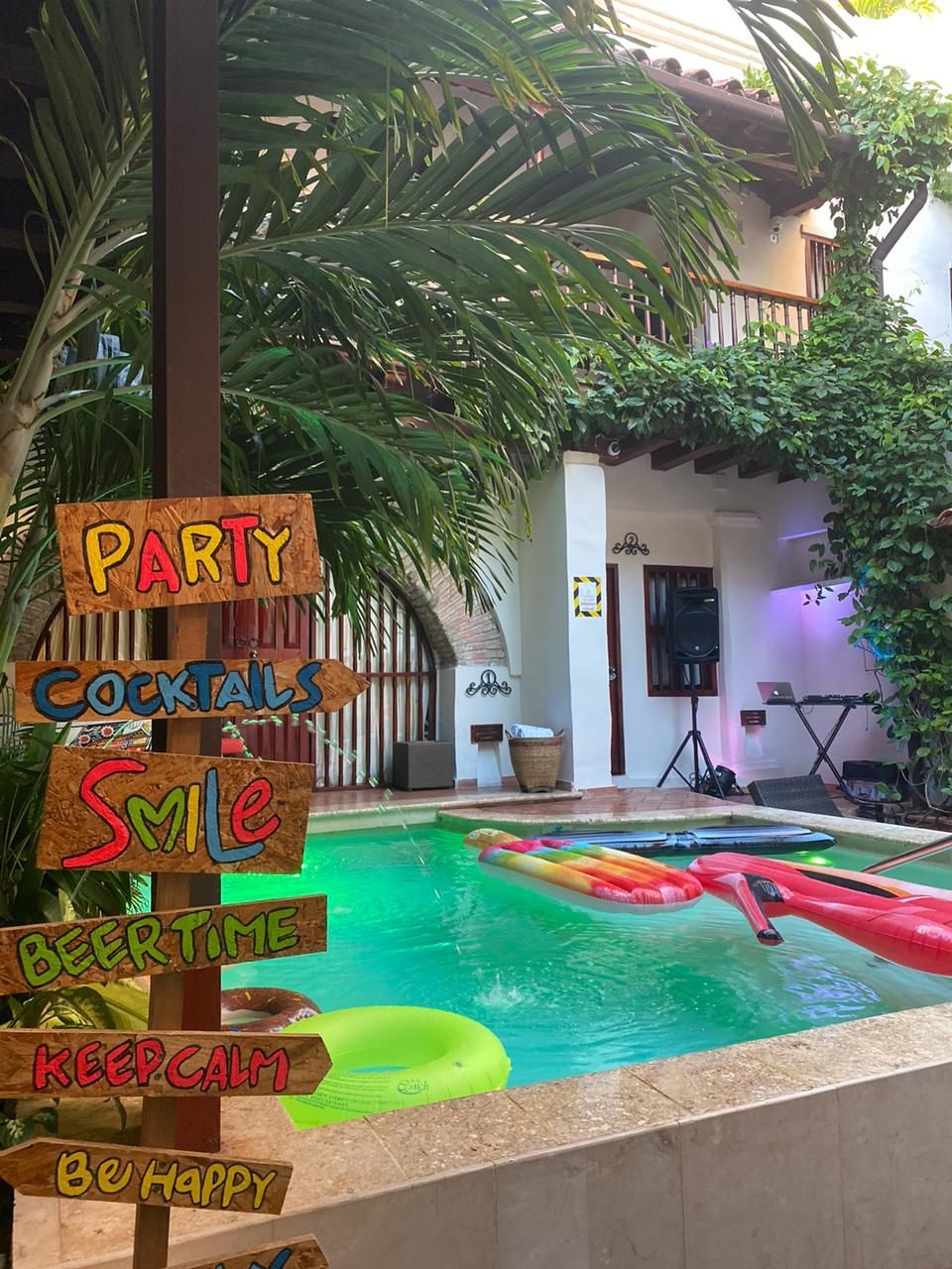 A swimming pool with a sign that says party cocktails on it.