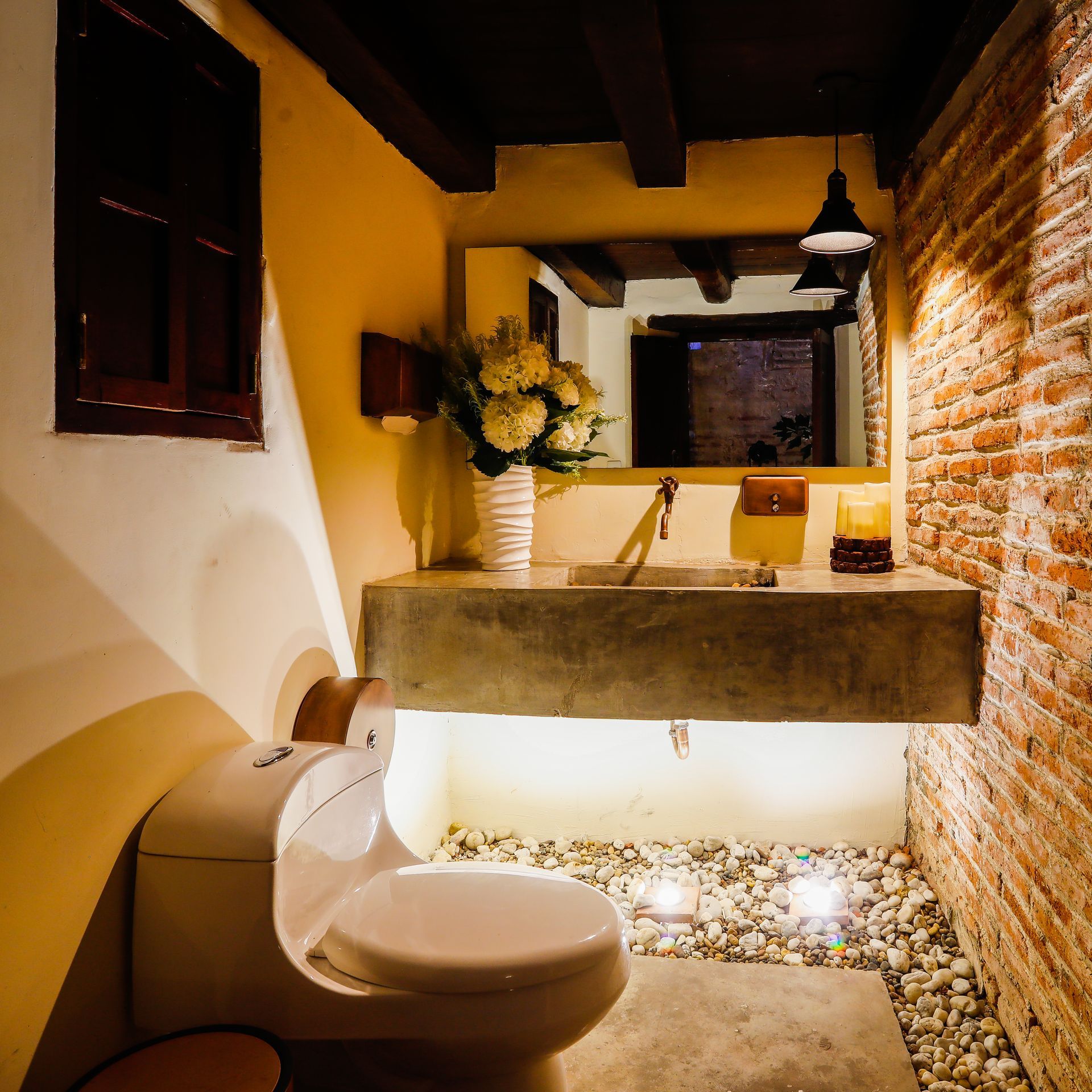 A bathroom with a toilet a sink and a mirror