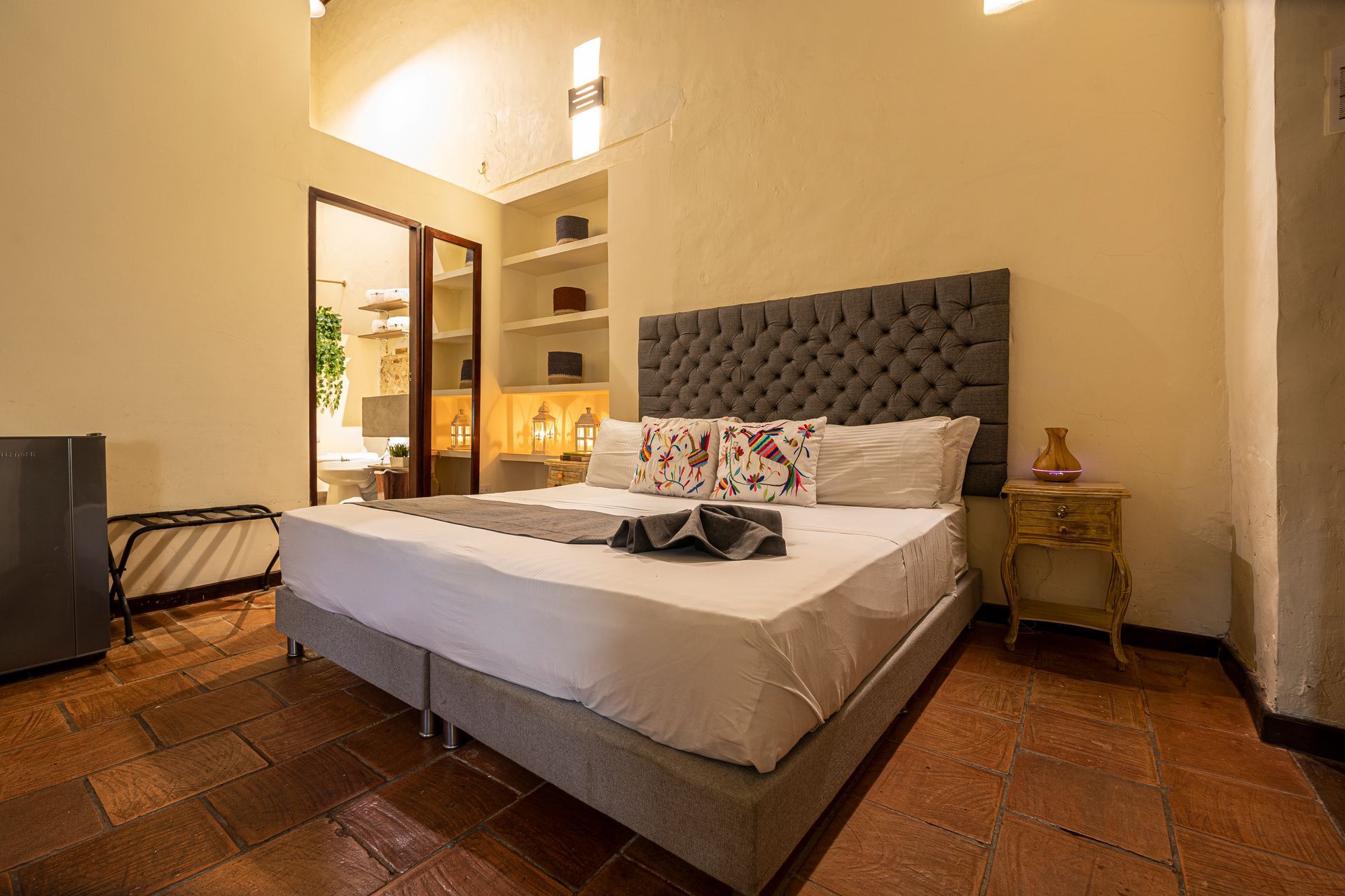 A bedroom with a king size bed and a nightstand.