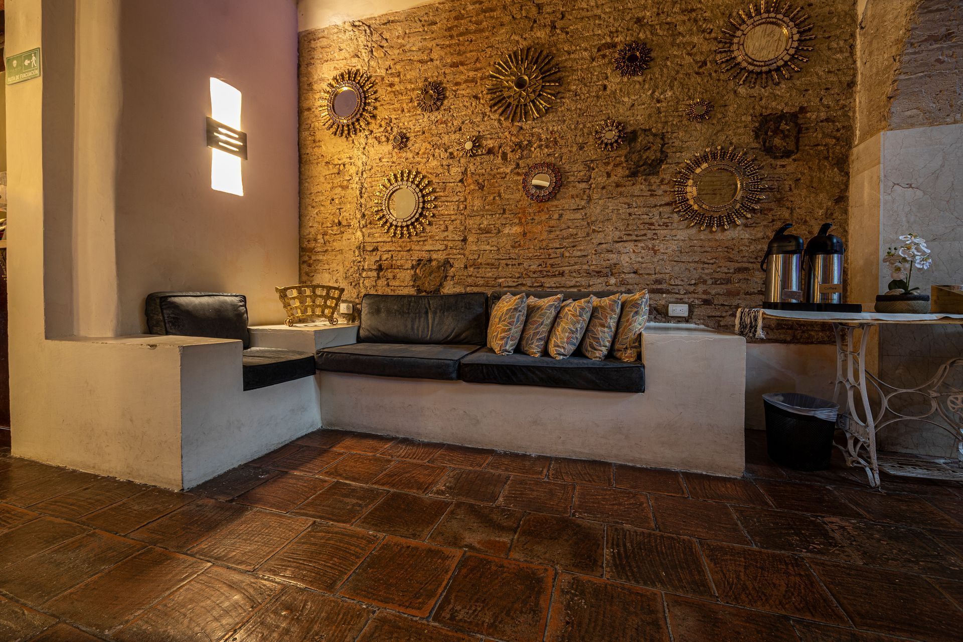 A living room with a brick wall and a couch.