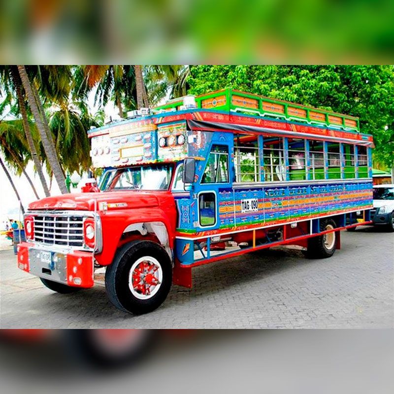 A colorful bus is parked on the side of the road