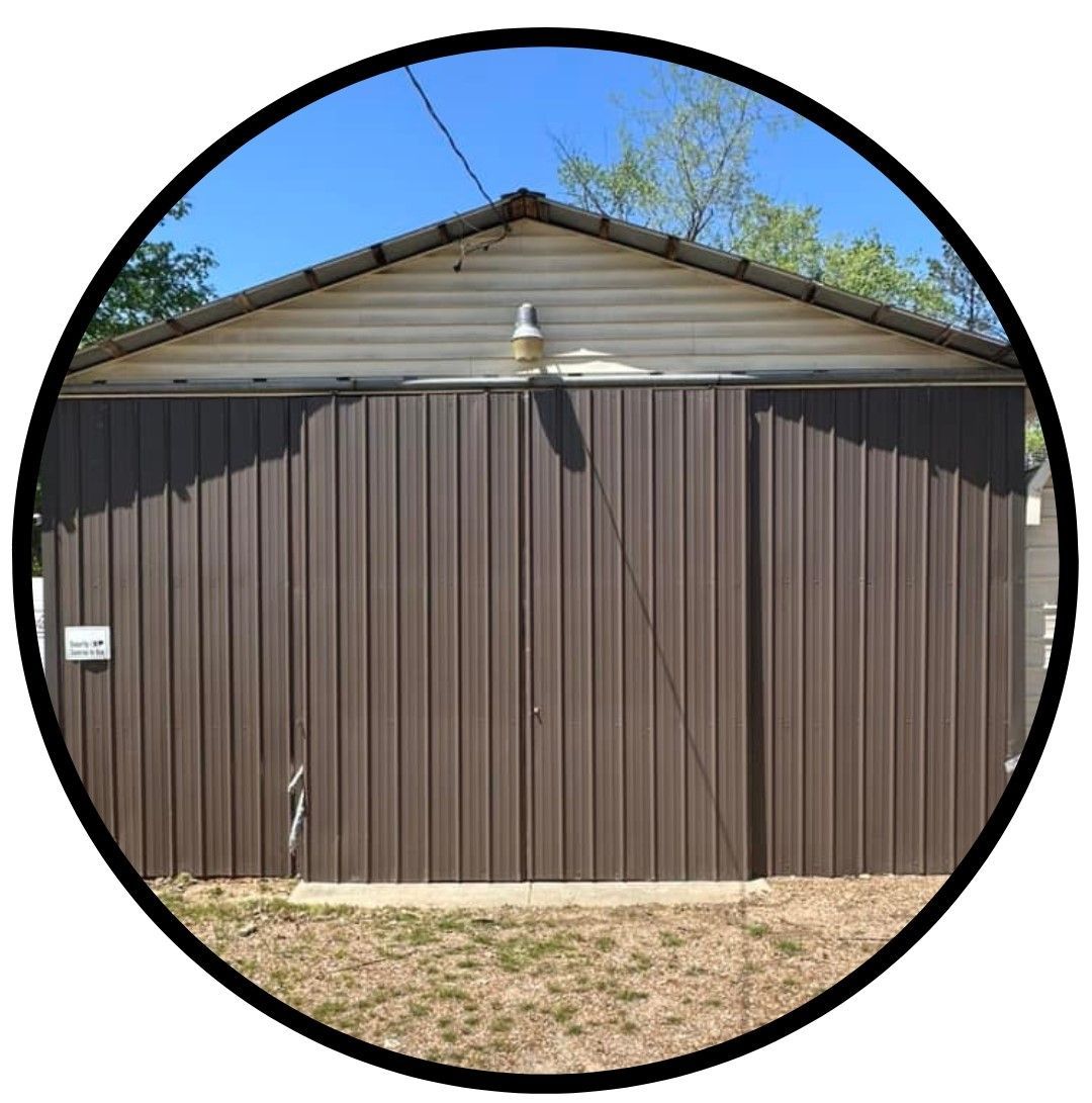 A brown metal garage door with a white roof in a circle.