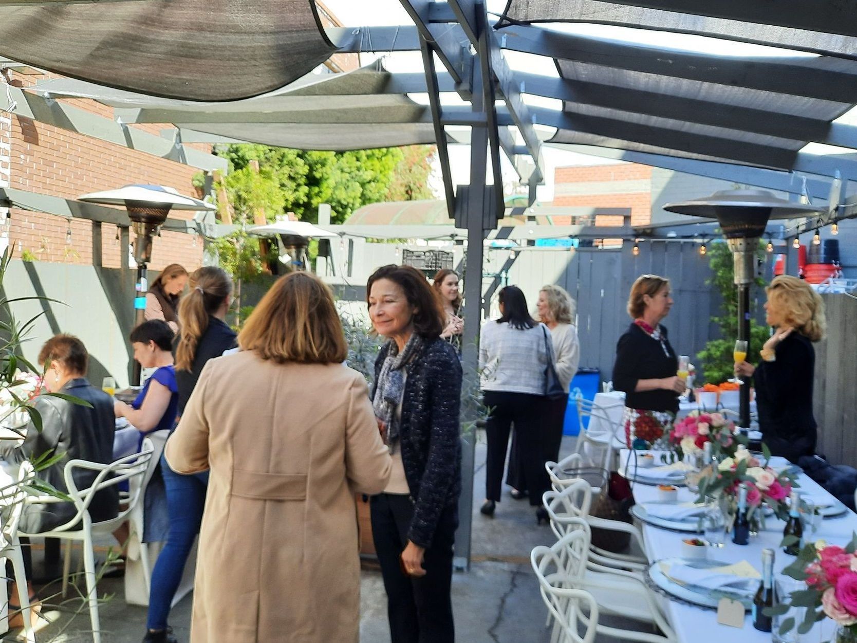 A group of people are standing around a table in a restaurant.