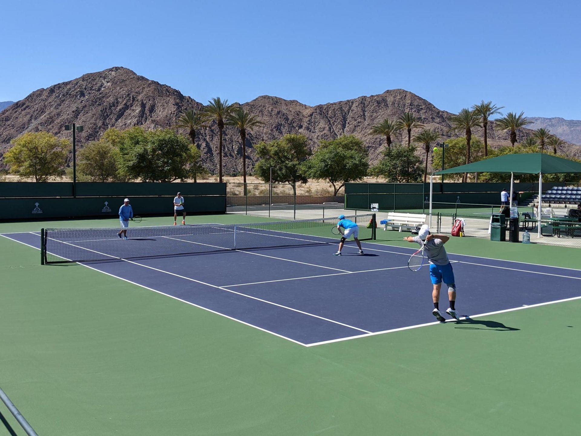 A group of children are playing tennis with rackets and balls