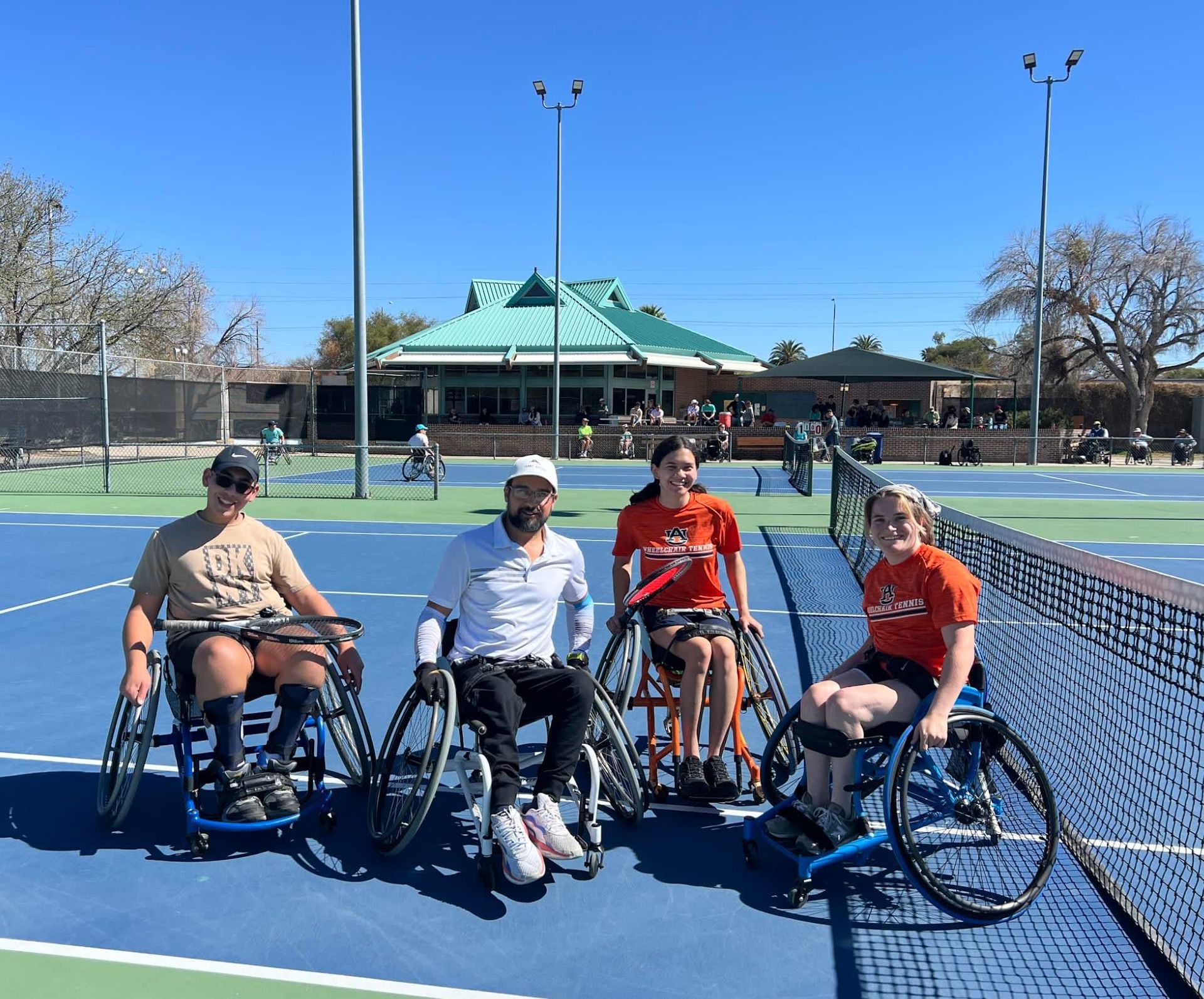 A group of people in wheelchairs on a tennis court