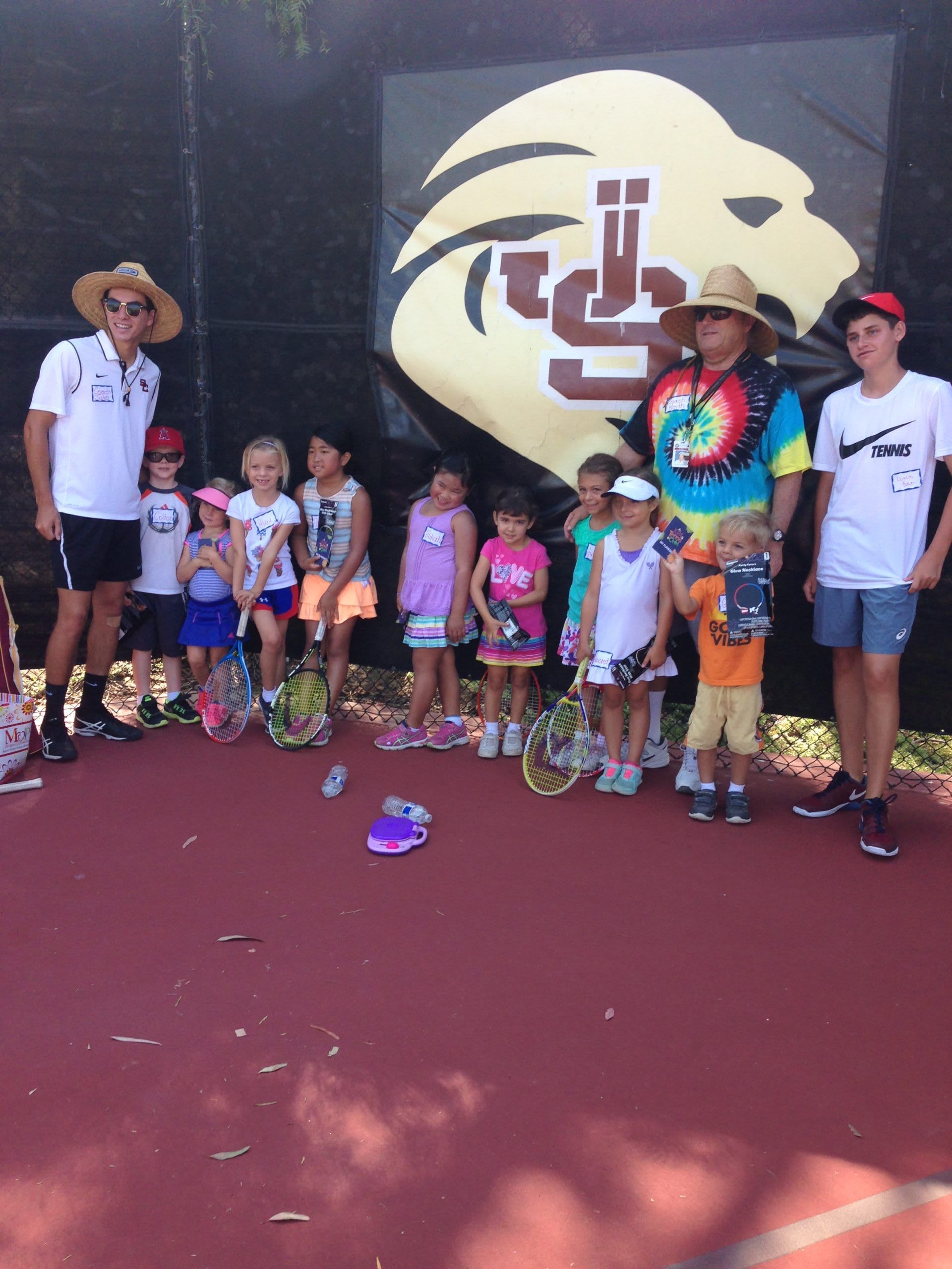 A group of people standing in front of a lion logo