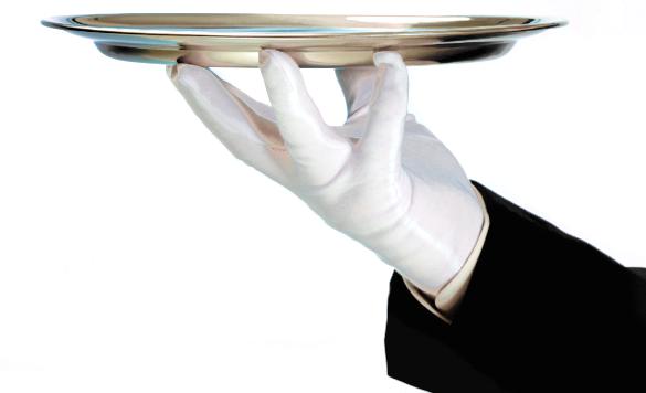 A person wearing white gloves is holding a silver tray