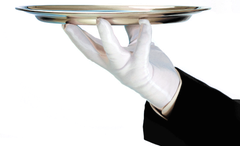 A person wearing white gloves is holding a silver tray