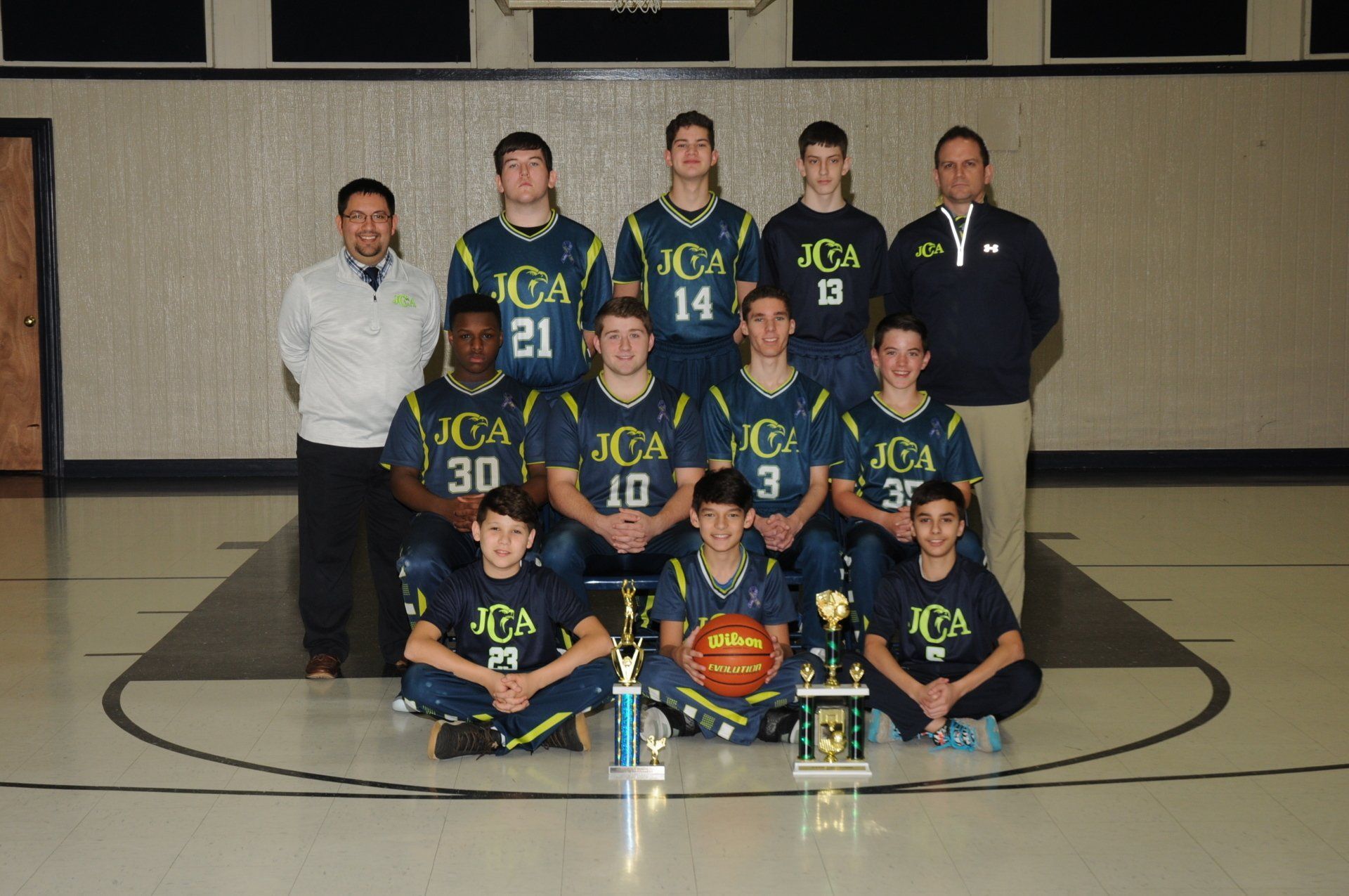 A boys basketball team poses for a team photo