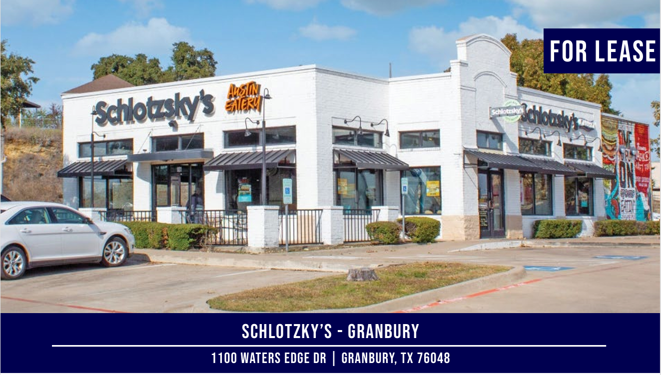 Exterior of a white-painted Schlotzsky's building in Granbury, Texas, with a 