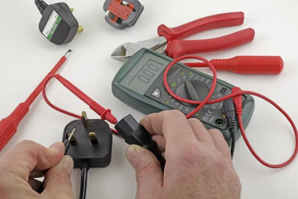 Hands Using a Multimeter and Probes — Eurocoast Appliance Service In Tuggerah, NSW